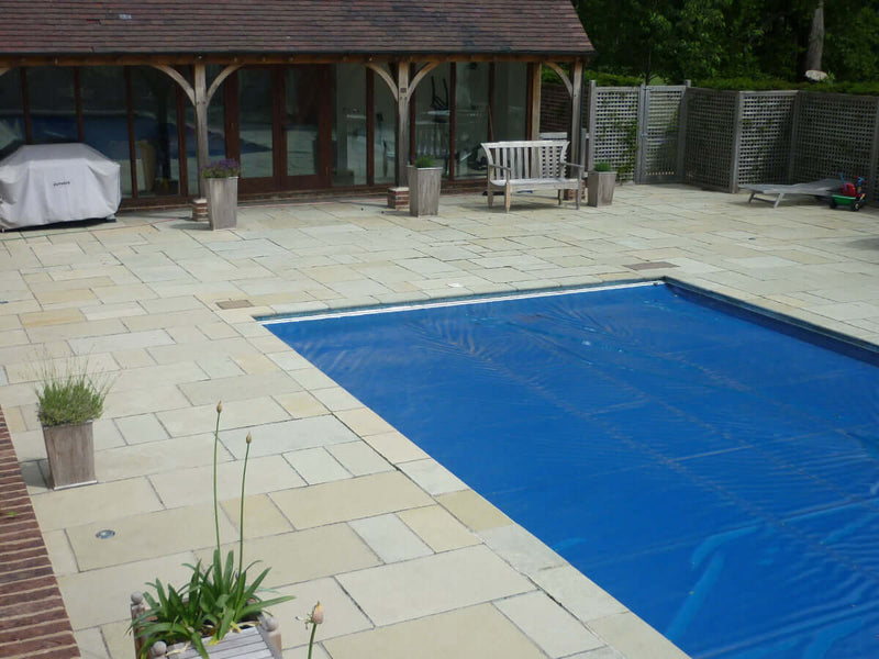 Amber limestone paving surrounding a swimming pool