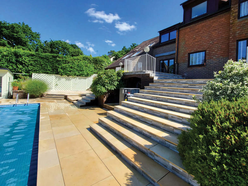 Sawn mint sandstone steps leading down to a swimming pool